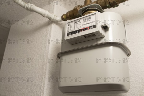 Symbolic image of energy costs in the household, natural gas, analogue gas meter in a flat,