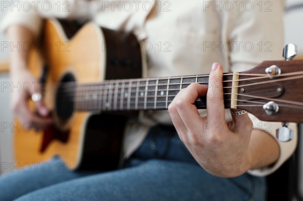 Side view female musician playing acoustic guitar