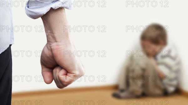 Family violence and aggression concept, furious angry man raised punishment fist over scared or