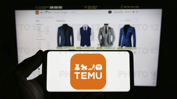 Stuttgart, Germany, 03-18-2023: Person holding smartphone with logo of US online shop company Temu