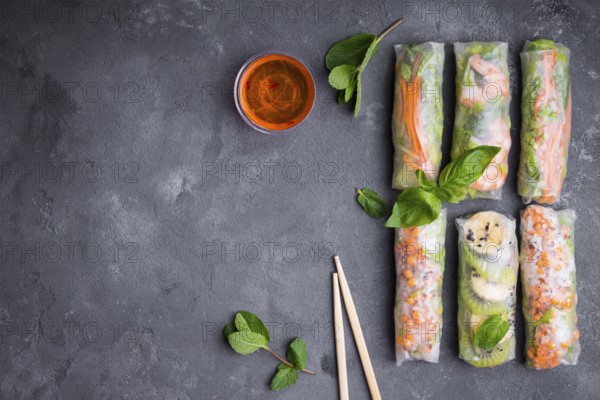 Fresh assorted spring rolls set background. Handmade asianChinese spring rolls, sauce, chopsticks.