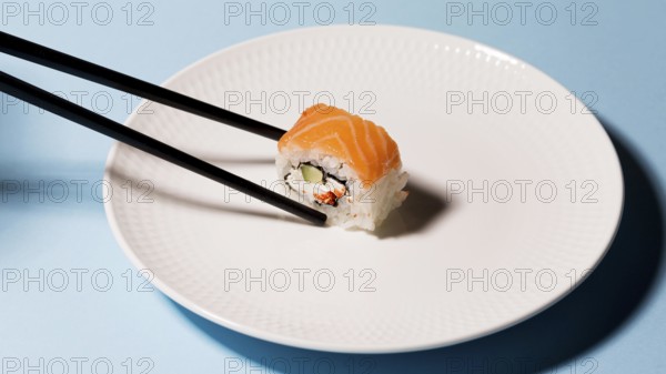 Plate with sushi roll chopsticks