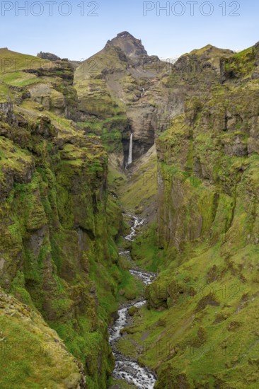 Mountain landscape with green canyon, waterfall and river in Múlagljúfur Canyon, Sudurland,