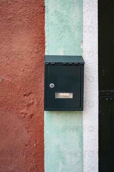 Letterbox on a red-blue-white house wall, colourful houses on the island of Burano, Venice, Veneto,