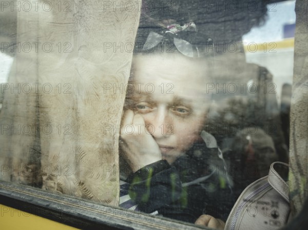 Arrival of refugees from occupied Kherson in the car park of a shopping centre, the two buses were