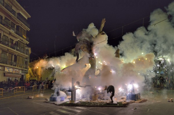 A burning Falla, a papier-mâché figure, at the Falles or Fallas spring festival, Pego, Province of