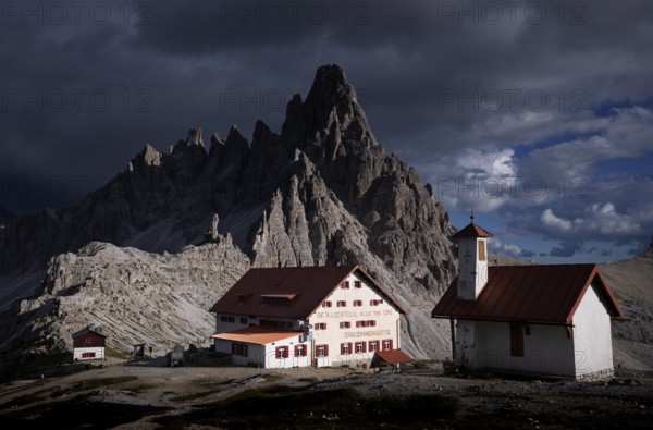 Stormy atmosphere, view of Dreizinnenhütte, chapel, Paternkofel, South Tyrol, Trentino, Sesto
