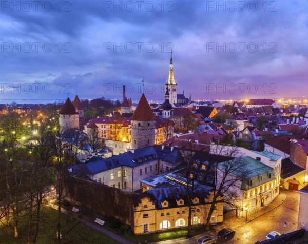Aerial view of Tallinn Medieval Old Town with St. Olaf's Church and Tallinn City Wall illuminated
