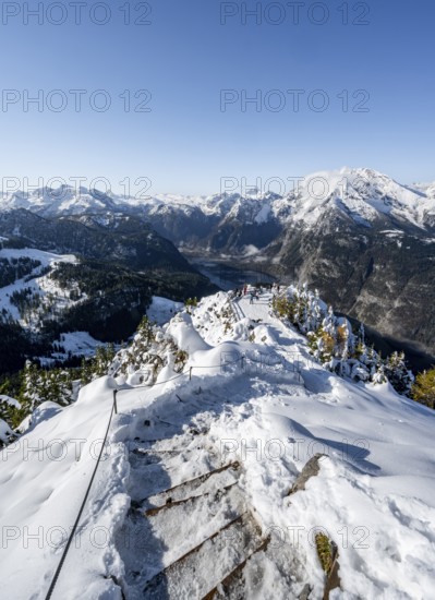 Hiking trail on the snow-covered summit of the Jenner with viewing platform in autumn, view of the