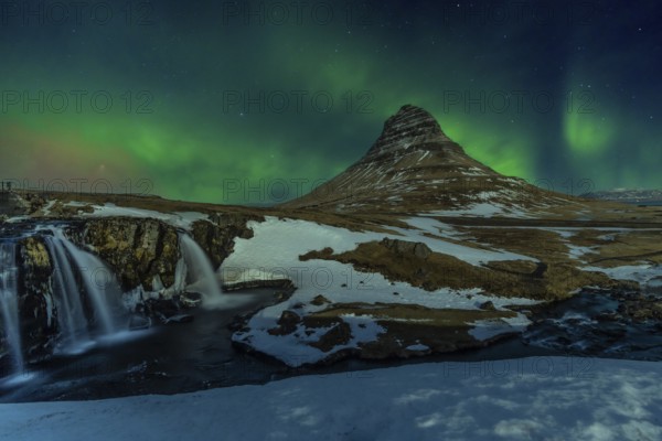 Beautiful Northern Lights on the picturesque Kirkjufell mountain in winter Iceland. Aurora Borealis