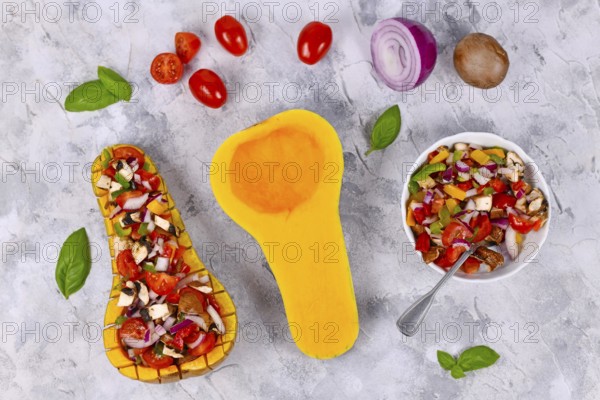 Top view of vegan baked Butternut squash vegetable filled with bell pepper, cherry tomatoes, red
