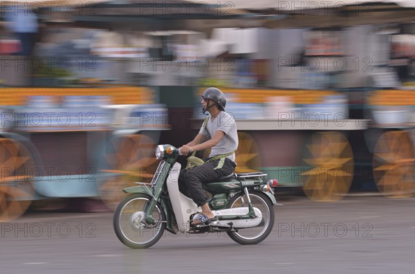 Moped rider at Djemaa el Fna market square, historic center, Marrakesh, Marrakesh-Tensift-El Haouz