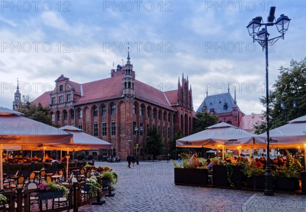 The lights come on in the restaurants in Panni Marii Street in the historic centre of Thorn in the