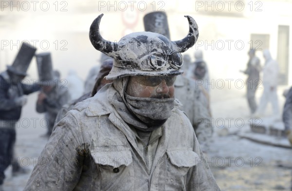 Man wearing viking helmet, Els Enfarinats flour fight, rebels, armed with flour, eggs and