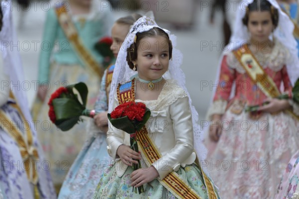 Fallas festival, girls in a traditional costume during the parade in the Plaza de la Virgen de los
