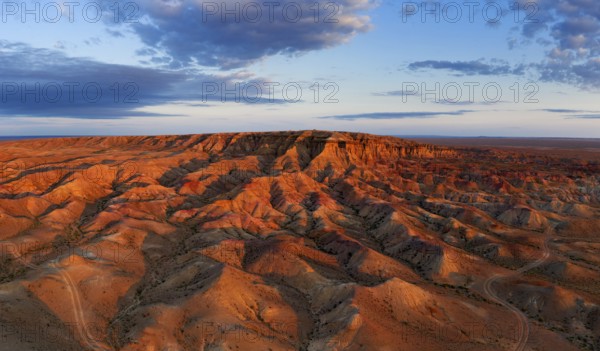 Aerial panorama of textural colorful striped canyons Tsagaan suvarga, White stupa at sunrise.