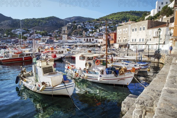 Amazing Hydra town and harbor with white fish boats and pleasure boats on island Hydra with steep