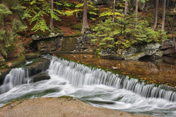 Water cascade on szklarka stream in autumn forest of Karkonoski National Park, Karkonosze