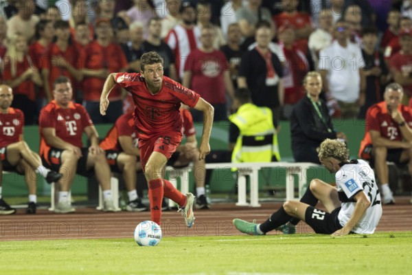 Football match, Thomas MÜLLER FC Bayern Munich left with the ball past Philipp STROMPF SSV Ulm on
