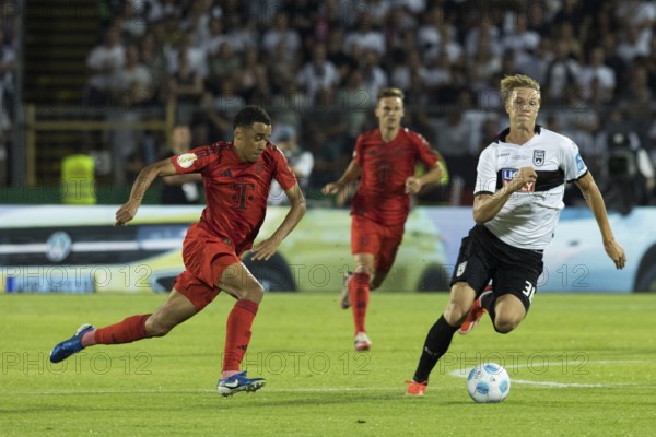 Football match, Jamal MUSIALA FC Bayern Munich left in a duel for the ball with Luka-Mikael