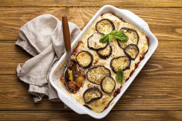 Greek mediterranean dish Moussaka with baked eggplants, ground beef in white ceramic casserole with
