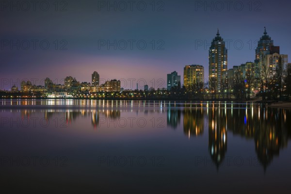 Night view of modern buildings in the Obolon district of Kiev, Ukraine, close to the Dnieper River,