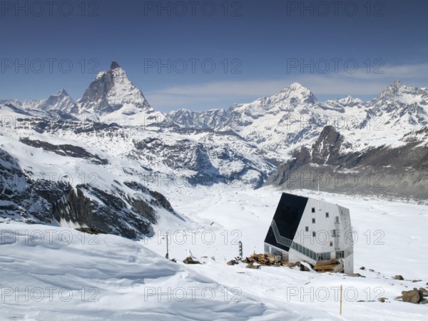 view of the Monte Rosa mountain hut and Gorner Glacier with the Matterhorn behind in the Valais