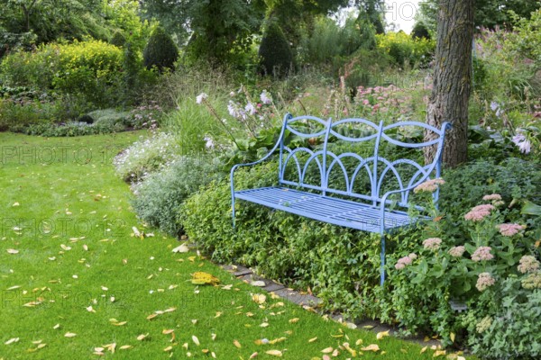 Blue bench in the district educational garden, Burgsteinfurt, Münsterland, North Rhine-Westphalia,