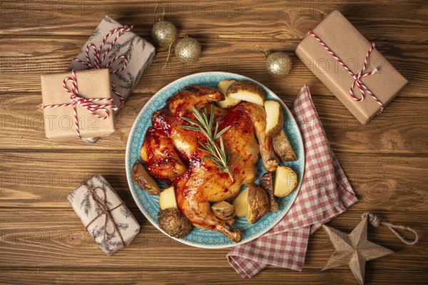 Festive Christmas dinner with roasted whole chicken top view on wooden rustic background with Xmas
