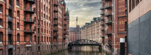 panoramic view of canal and historic buildings in old warehouse district Speicherstadt in Hamburg,