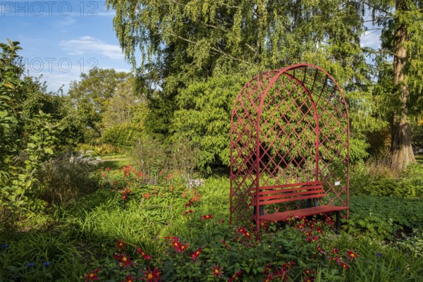 Red bench in the district educational garden, Burgsteinfurt, Münsterland, North Rhine-Westphalia,