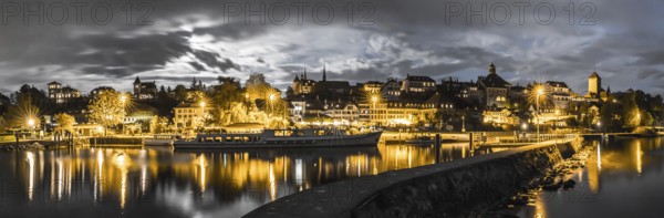 panorama view of the Swiss city Murten and harbor skyline at night under a full moon