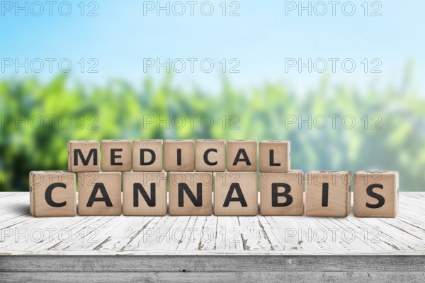 Medical Cannabis sign on a natural desk with a field of herbs in the background