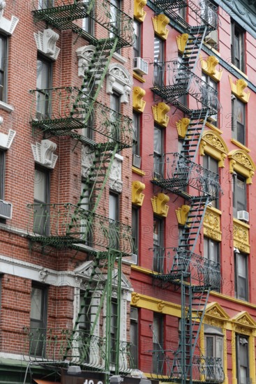 Colourful fire escape on the rustically decorated building facade, Manhattan, New York City, New