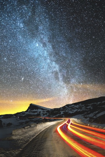 Night landscape. Night sky with a north hemisphere Milky Way and stars. The night road illuminated