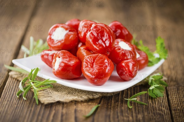 Fresh made Red Pepper (stuffed with cheese) on an old and rustic wooden table (selective focus,