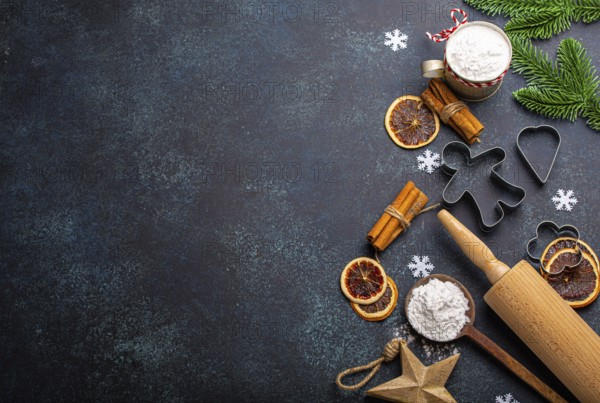 Christmas and New Year festive baking background with kitchen tools, flour, fir tree branch, metal