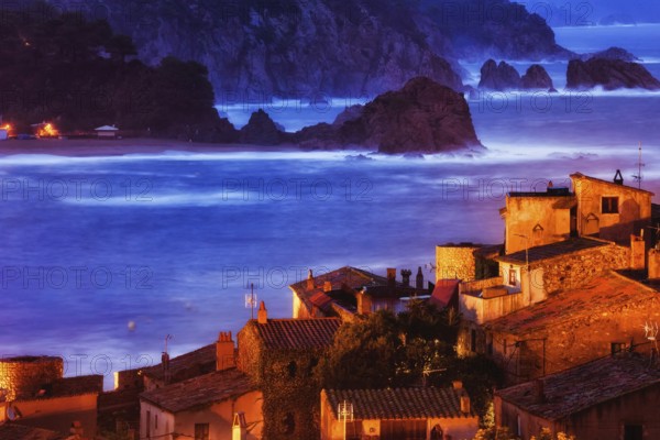Old coastal town of Tossa de Mar at dusk on Mediterranean Sea, view over historic houses of Vila