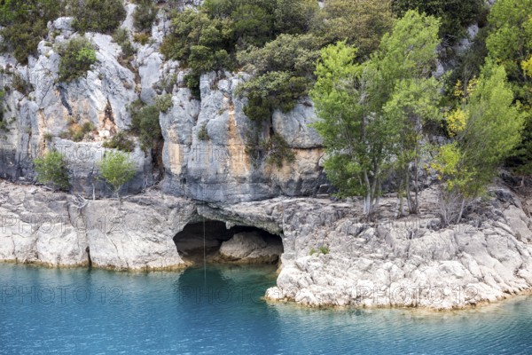Cave on the rocky shore of Lac de Sainte-Croix, near dam, Provence-Alpes-Côte d'Azur, Provence,