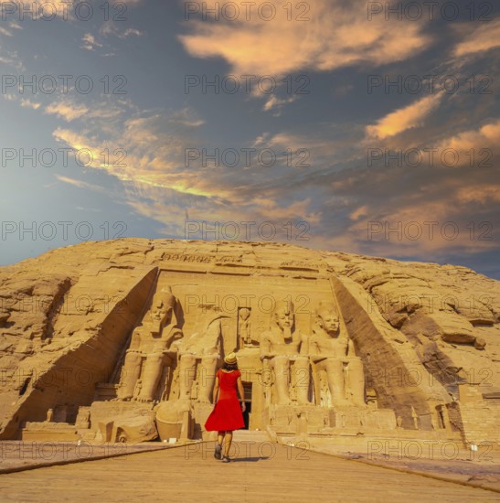 A European tourist in red dress walking towards the Abu Simbel Temple in southern Egypt in Nubia
