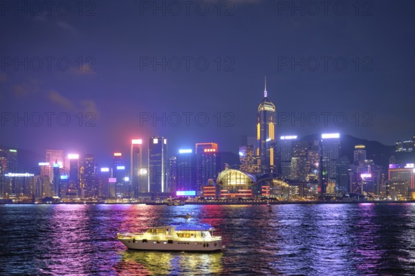 Hong Kong skyline cityscape downtown skyscrapers over Victoria Harbour in the evening illuminated