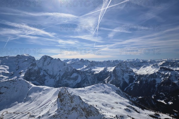 View of a ski resort piste and Dolomites mountains in Italy from Passo Pordoi pass. Arabba, Italy,