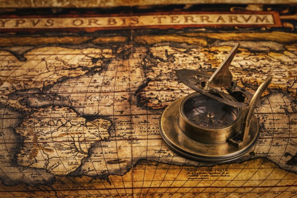 Travel geography navigation concept background, old vintage retro compass with sundial on ancient