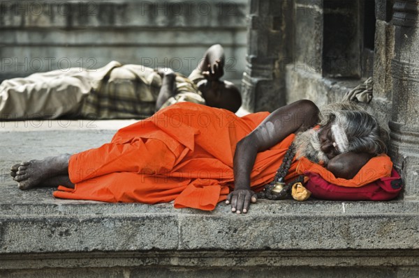 TIRUVANAMALLAI, INDIA, JANUARY 7, 2010: Sadhu, religious ascetic or holy person, sleeping in Hindu