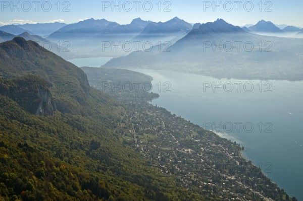 View from the summit of Mont Baron over the village of Veyrier-du-Lac to Lac dAnnecy in autumn mist