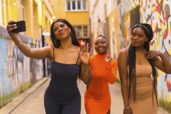 San Sebastián, Gipuzkoa Spain, February 2021: Three girls taking a selfie. Fashionable urban style