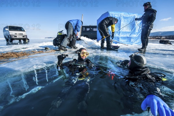 Scuba divers after an ice dive, Lake Baikal, Pribaikalsky National Park, Irkutsk Province, Siberia,