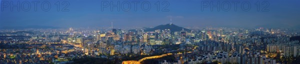 Panorama of Seoul downtown cityscape illuminated with lights and Namsan Seoul Tower in the evening
