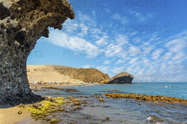 Summer at Monsul Beach in the Cabo de Gata Natural Park, created with eroded lava formations in the