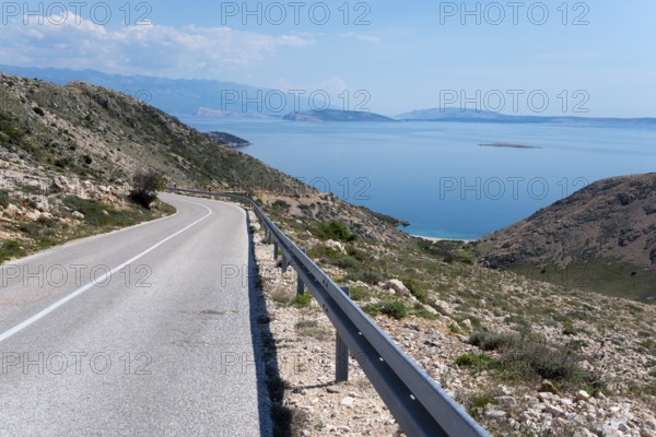 Winding road through mountainous landscape with sea view, mountain road towards Stara Baška, Stara